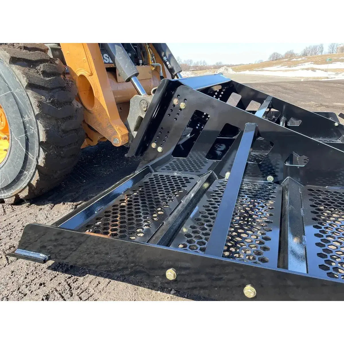 The Land Plane by Top Dog Attachments is captured in this image, emphasizing its robust design and effectiveness in transforming uneven terrain into a smooth, well-graded surface. Top Dog Attachments Top Dog Attachments