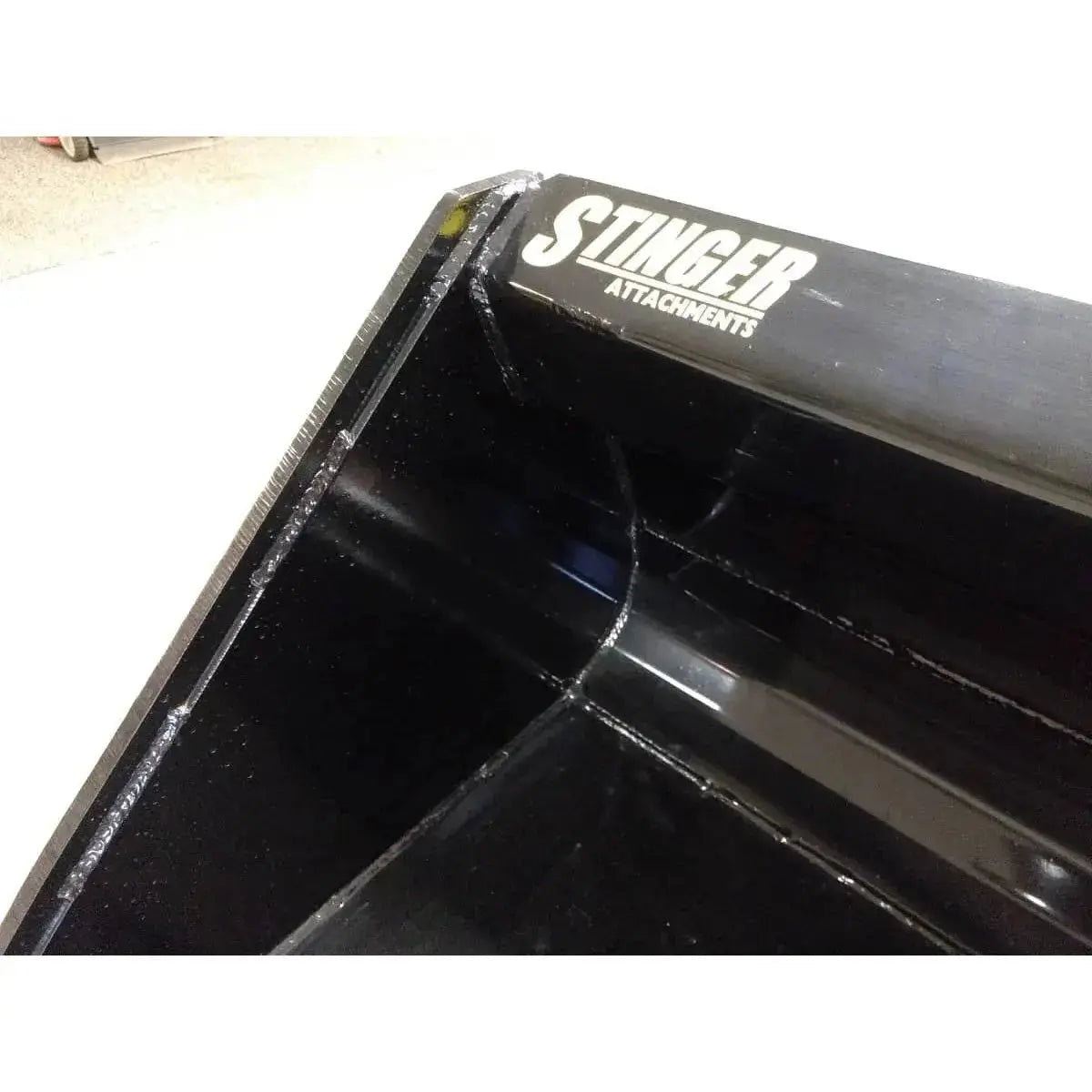 Reliable Series 1 material bucket crafted for skid steer loaders, delivering power. Stinger Attachments Stinger Attachments