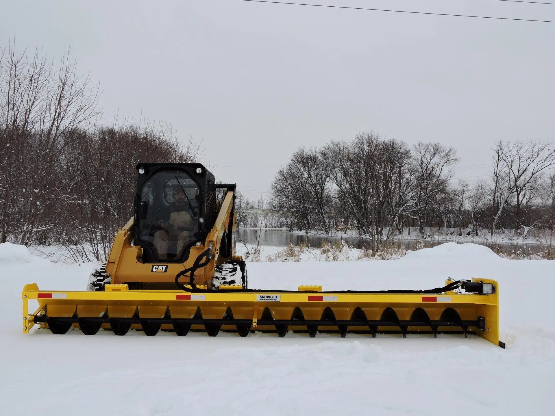 Berlon Industries' Snowgrr™ on a Tractor, an essential tool for efficient and powerful snow clearing in various terrains.