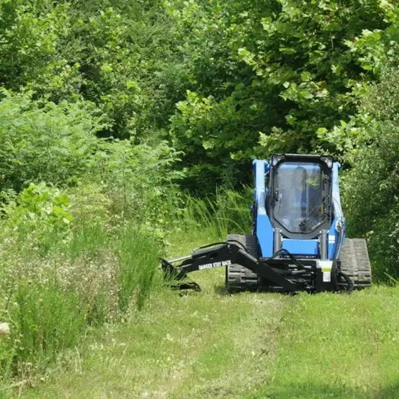Navigate through dense vegetation with ease using Blue Diamond's Swing Arm Brush Cutter, a reliable attachment for skid steers. Blue Diamond