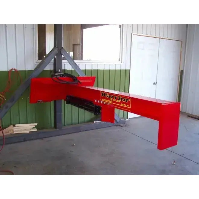 Operational image of TM Warrior Skid Steer Log Splitter Attachment, demonstrating its powerful log-splitting capabilities. TM Manufacturing TM Manufacturing